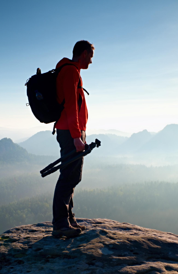 a man standing at a mountain top